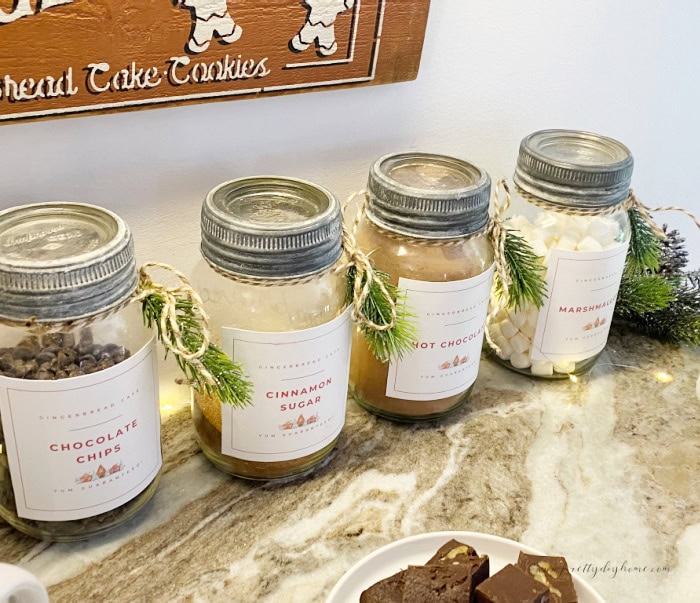 An inexpensive cocoa bar you can make ahead with old mason jars, free labels and easy to buy everyday ingredients from the grocery store.