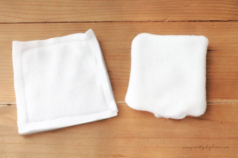 A pair of white fleece fabric diy hand warmers, one is sewn on three sides with a one inch gap. The second is turned right side out making the gap for filling visible.
