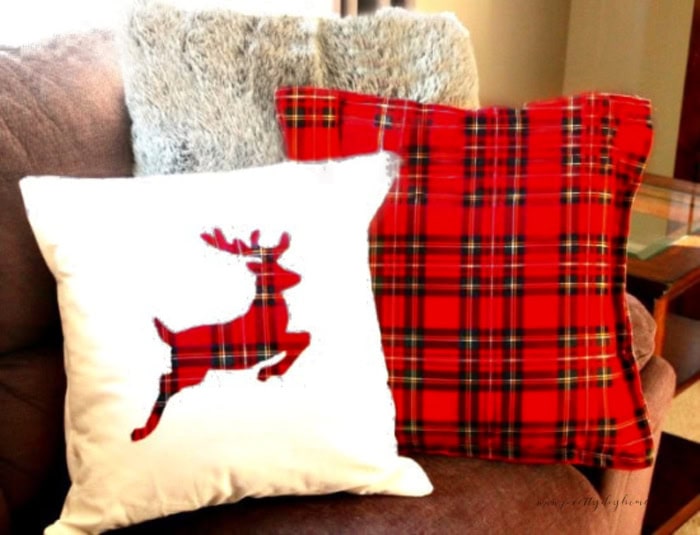 Two DIY Christmas pillow covers made with red tartan, one is plain red tartan envelope cover, the second one is an appliqued reindeer on white cushion cover.