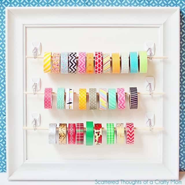 Washi tape organized onto a white frame.  You can see a couple dozen pretty rounds of washi tape in a rainbow of colors.  Although an organizer it looks like artwork.