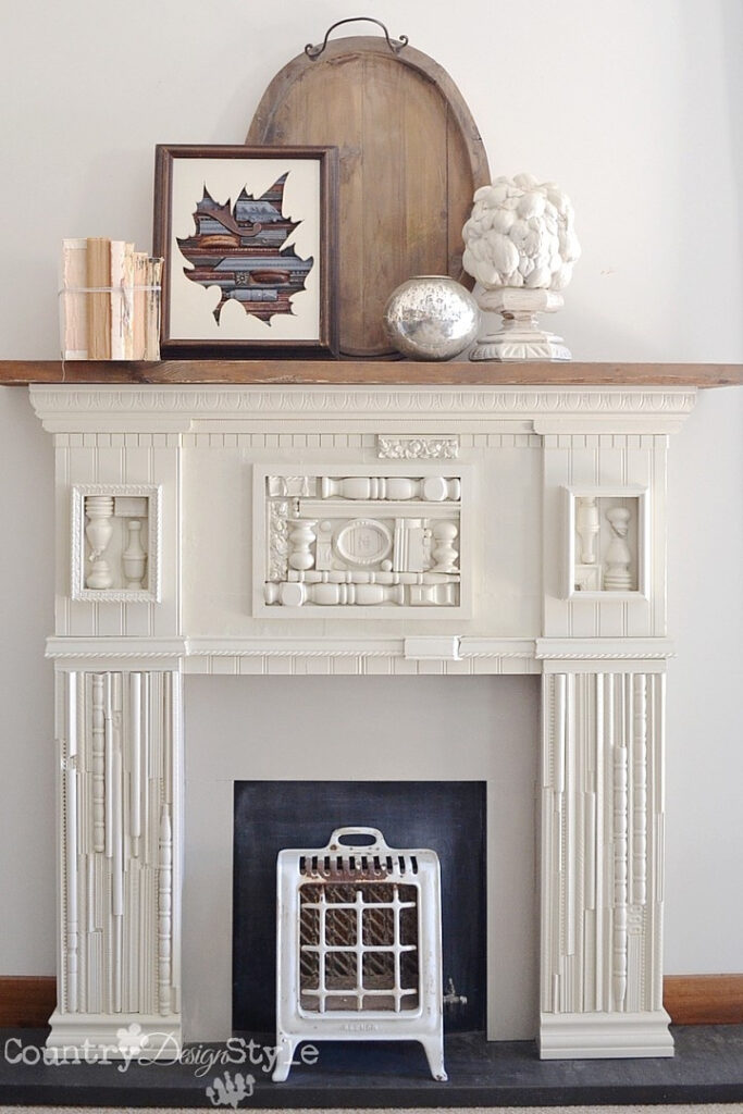 A large and striking diy faux fireplace with fun embellishments and trim made from different kinds of scrap wood, spindle, blocks etc.  Its a large extravagant showstopping fireplace.