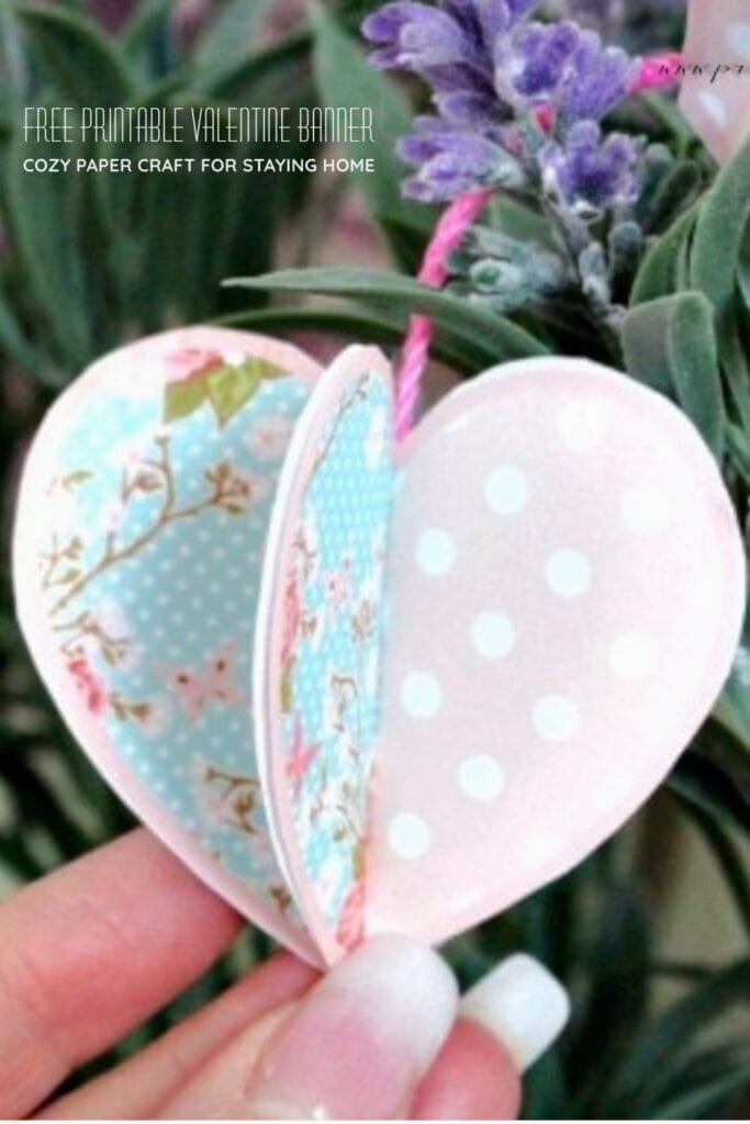 3D paper Valentine heart sewn onto twine with overlay text for a free printable Valentine banner craft