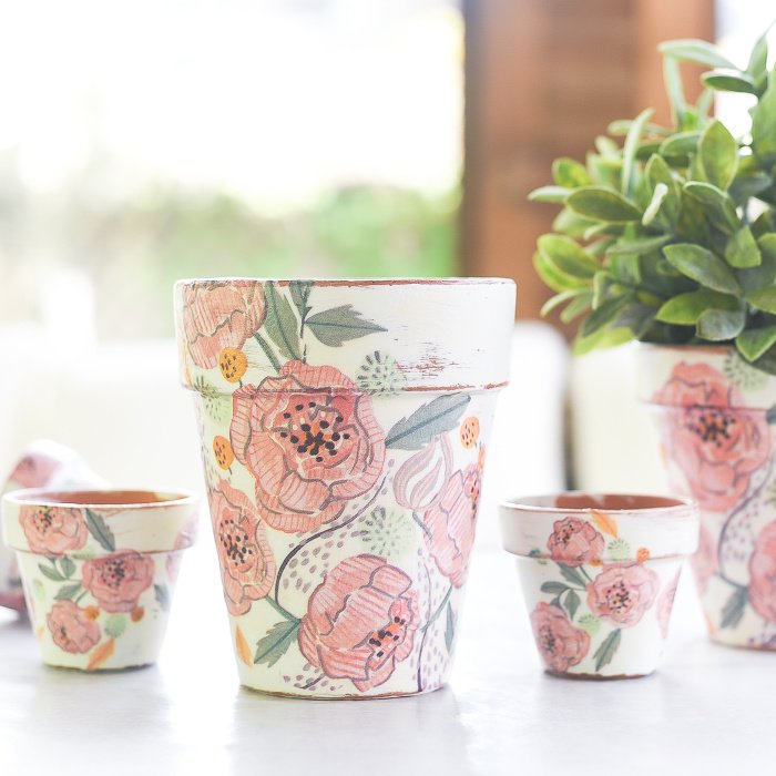 Floral covered clay pots in soft white and pastel roses.