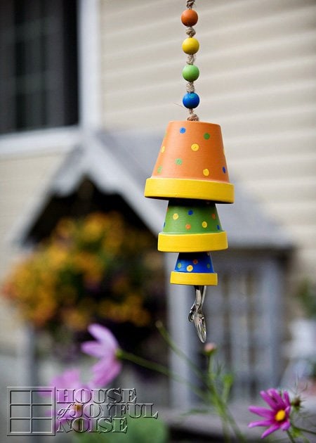 Brightly coloured terra cotta pot craft made into a fun hanging wind chime.  