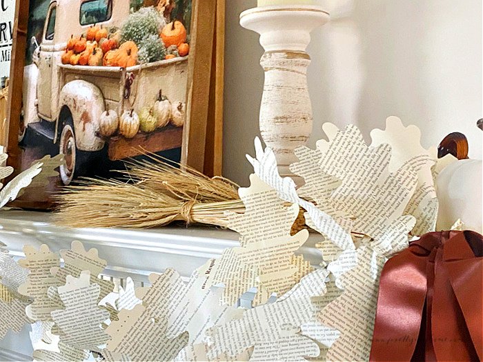 Two DIY dried wheat bundles laying on a mantel as part of a Fall Home Decor.