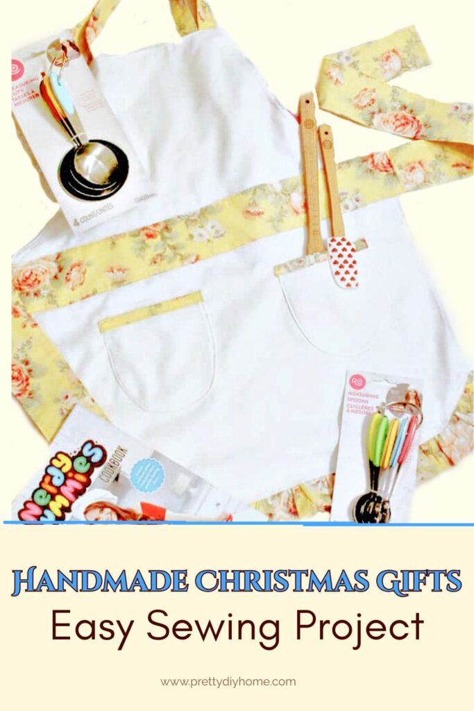 Finished handmade children’s apron with yellow ties styled with a kids cookbook and colourful baking tools, easy DIY Christmas gift idea with free pattern