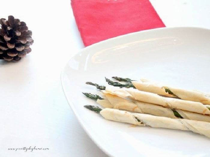 A serving of freshly baked Christmas make ahead appetizers.  Its a spear of asparagus wrapped in butter, garlic, and phyllo pastry,
