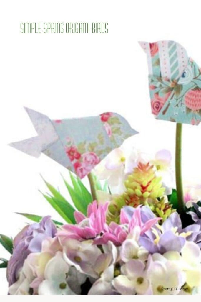 Two paper origami birds added to a pretty flower arrangement for Spring decor.