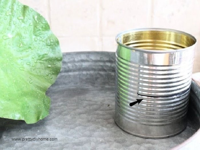 Using a tin can to make a balcony for a DIY fairy pond.