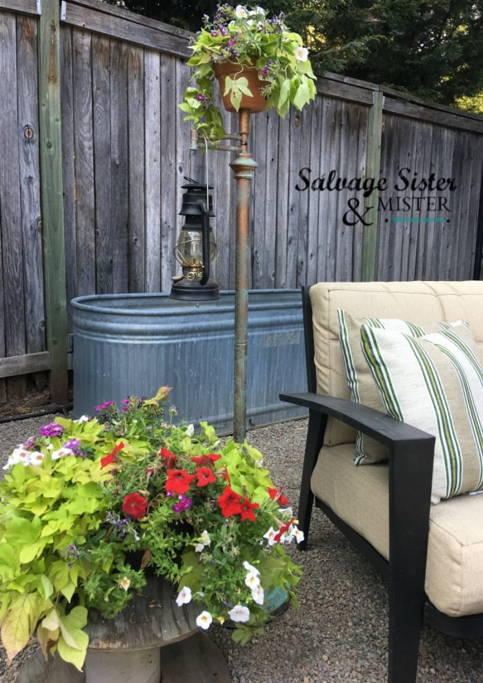 Upcycled vintage lamp turned into outdoor lantern stand with flowers for spring decor,