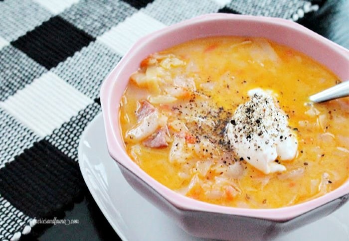 Cabbage soup recipe in a bowl served with sour cream.
