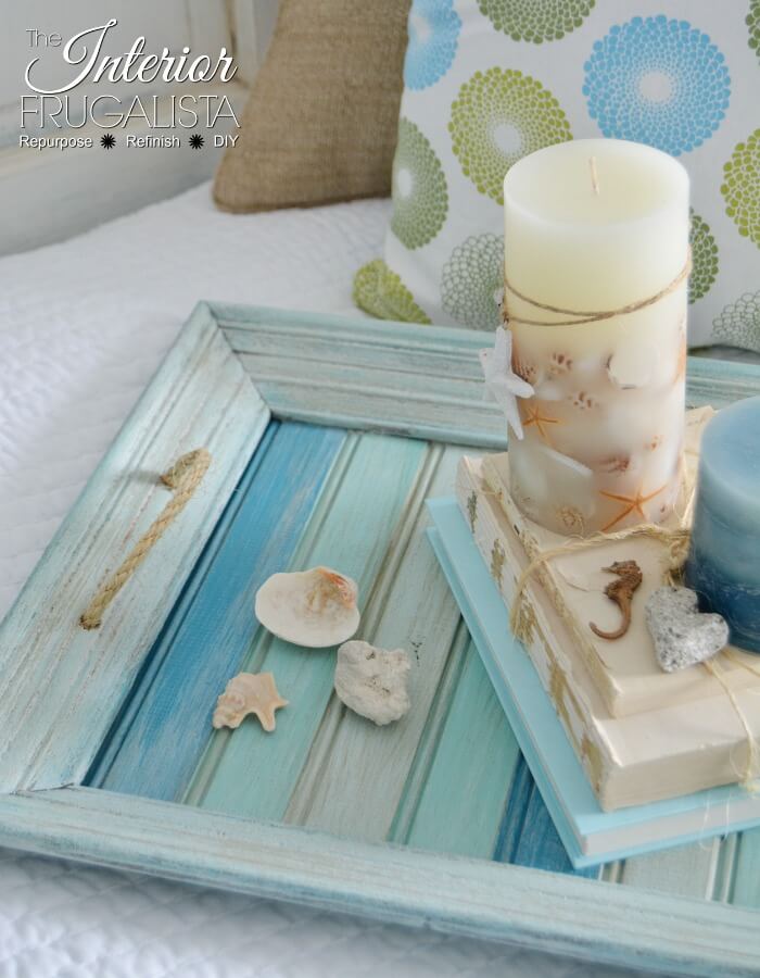 A picture frame craft idea that turns an thrift store frame into a coastal farmhouse tray.