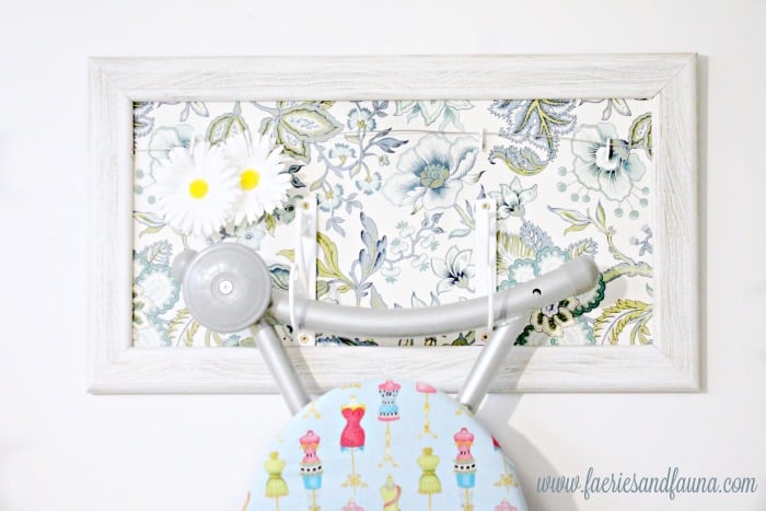 A DIY picture frame craft that upcycles an old picture frame into a coordinating ironing board hangar for the laundry room.