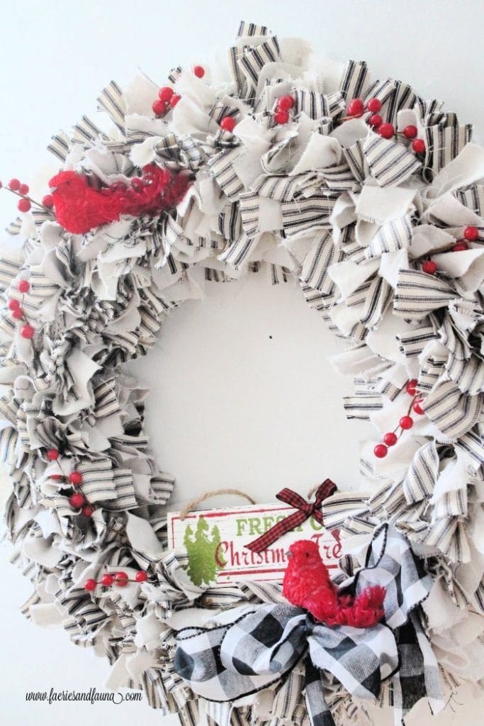 A DIY drop cloth craft wreath with ticking decorated for Christmas