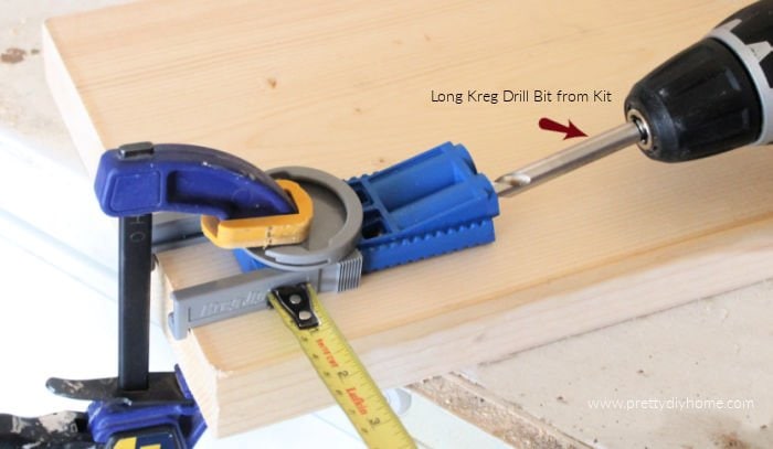 A kreg jig with a jigsaw using it to drill a hole in wood for a DIY Bench