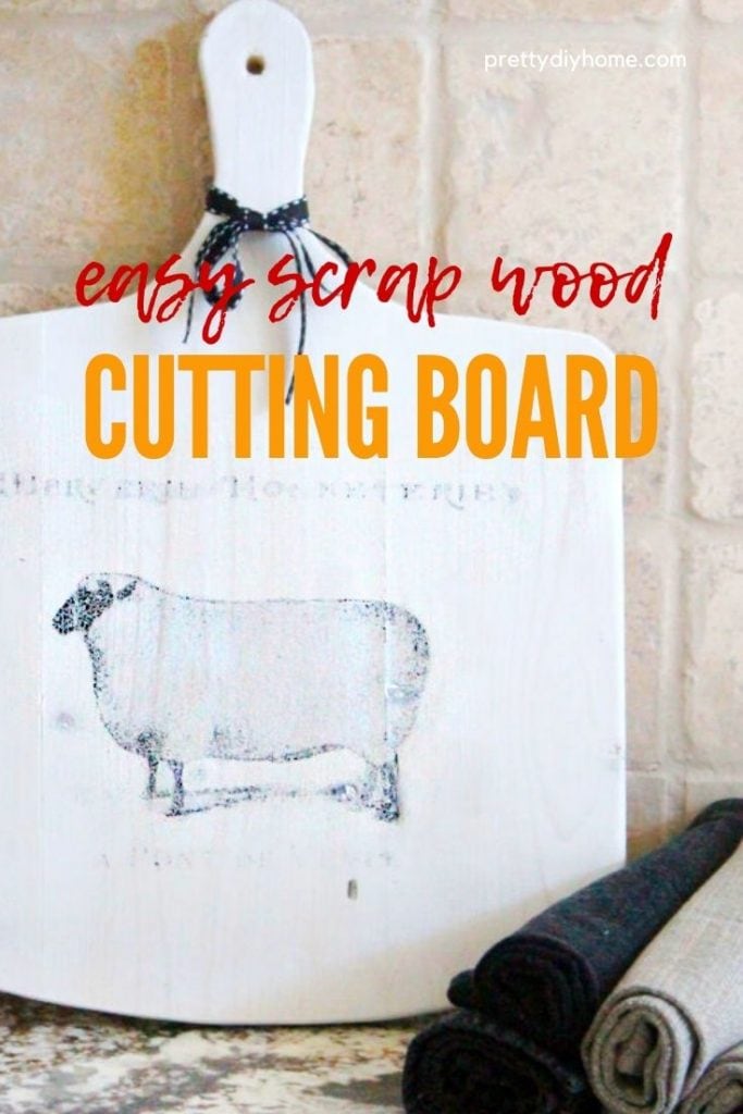 A DIY cutting board made using scrap wood in white with a french sheep graphic.