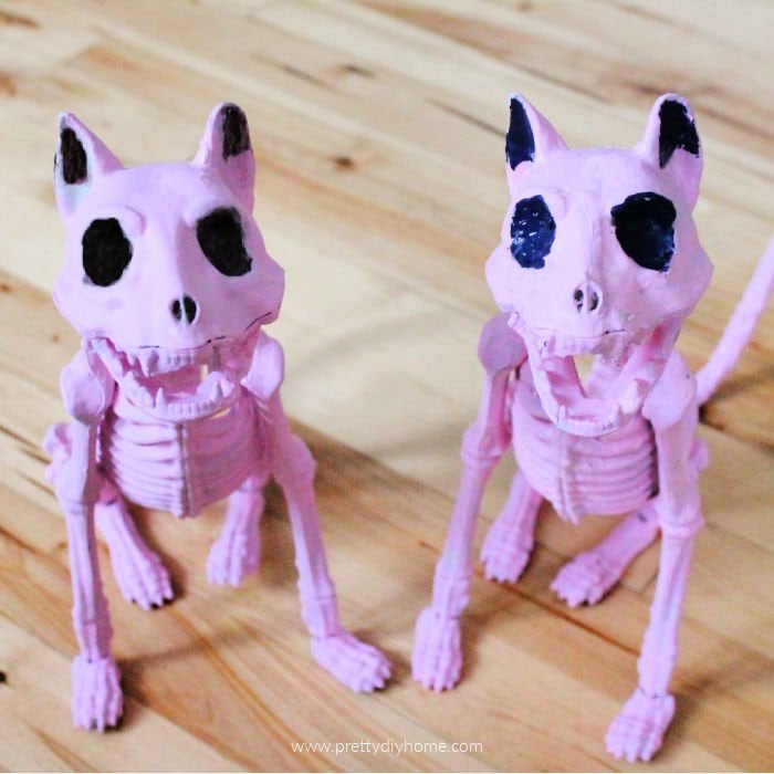 Two matching pink Halloween cats with black eyes.