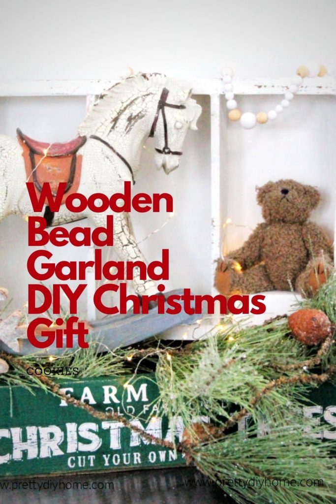 A Christmas vignette with a DIY Farmhouse Wooden Bead Garland in a Christmas display.