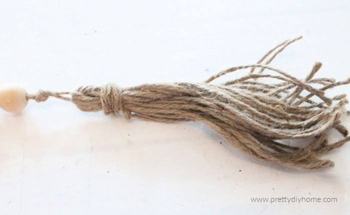 A small tassle for the end of a DIY wooden farmhouse bead garland.