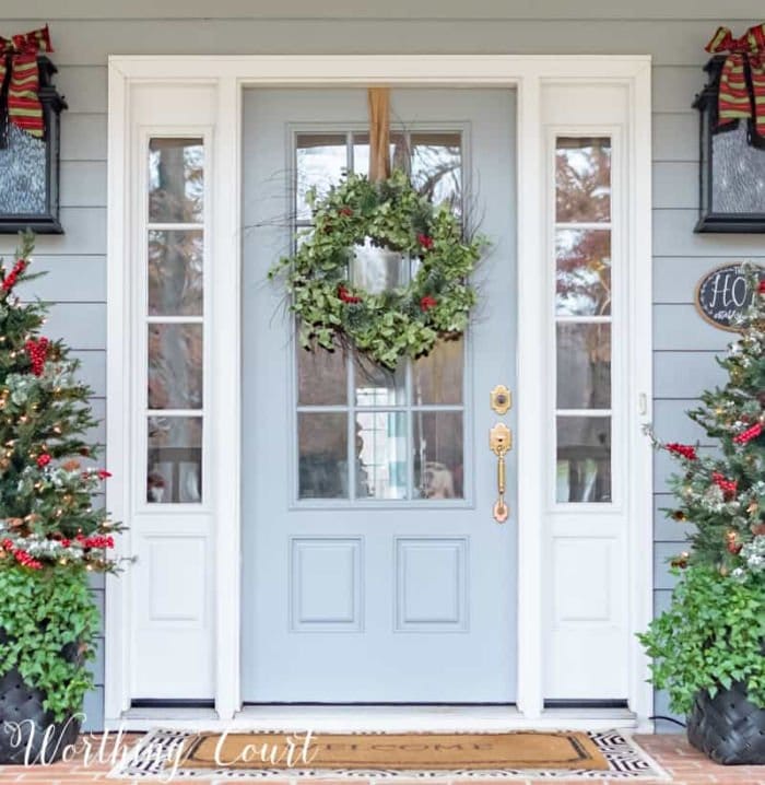 A traditionally decorated Christmas porch with green wreath.