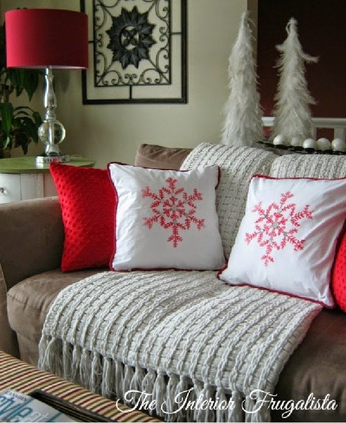 Traditional Christmas cushion in white with a red snowflake.