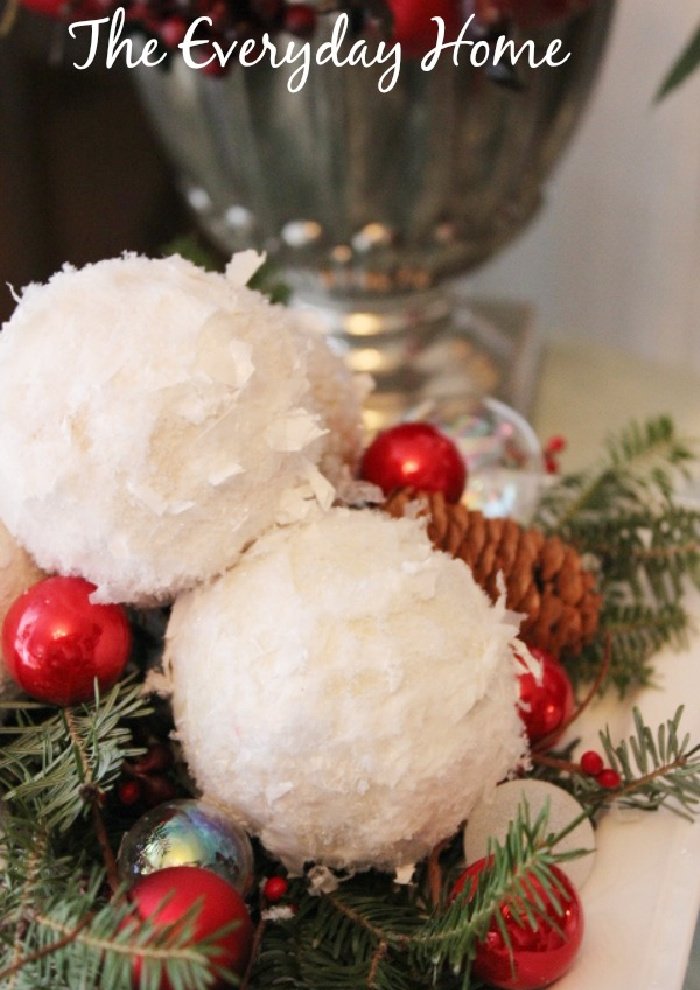 A Christmas centerpiece in traditional Christmas colours including homemade snowballs