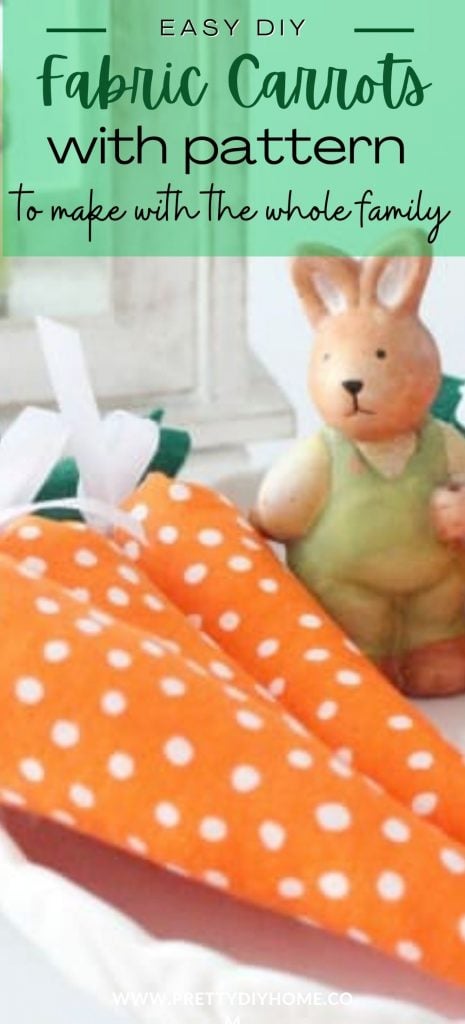 Three DIY fabric carrots made with orange polka dot fabric, white ribbon and green felt leaves.  They rabbits are guarded by a cute ceramic Easter bunny.