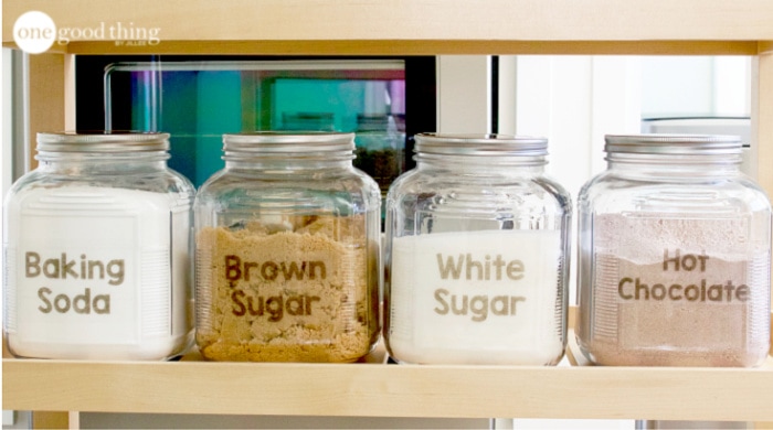 Four large pantry jars with DIY printable labels.