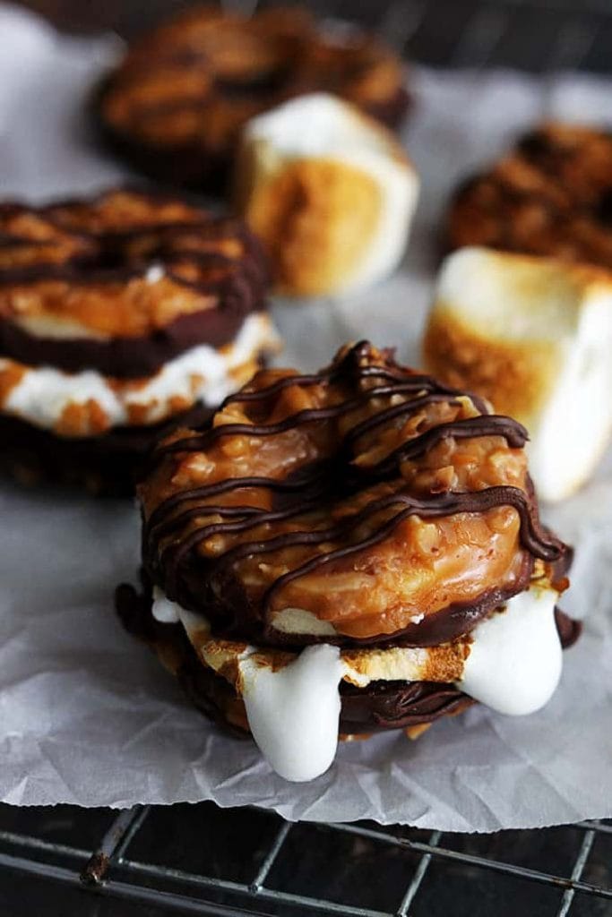 Samoa smore cookie recipe Two somoa cookies sandwich a freshly roasted marshmallow. A delicious sweet dessert treat for camping.