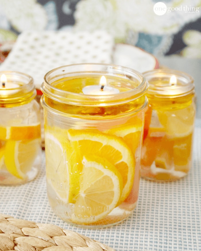 A mason jar floating candle with oranges and lemons.  