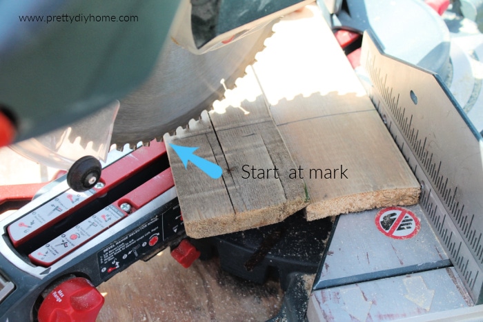 Cutting pallets for a DIY wood pallet Christmas Tree craft idea