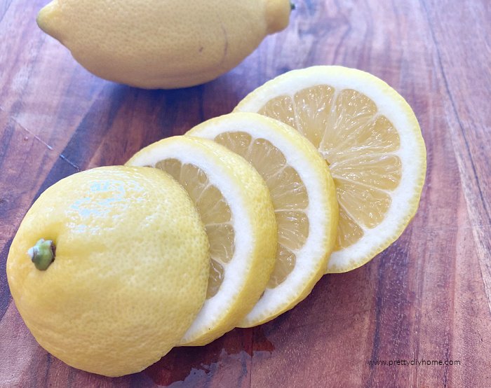 Slicing the center out of lemons to use as garnish while leaving the ends for juice and lemon rind.