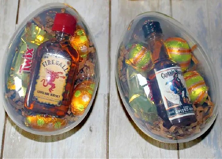 Two adult easter eggs for an adult Easter egg hop.  you can see each egg is filled with a small bottle of alcohol and then some Easter chocolates.