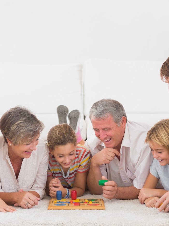 A family playing a board game after having a board game adult Easter egg hunt .