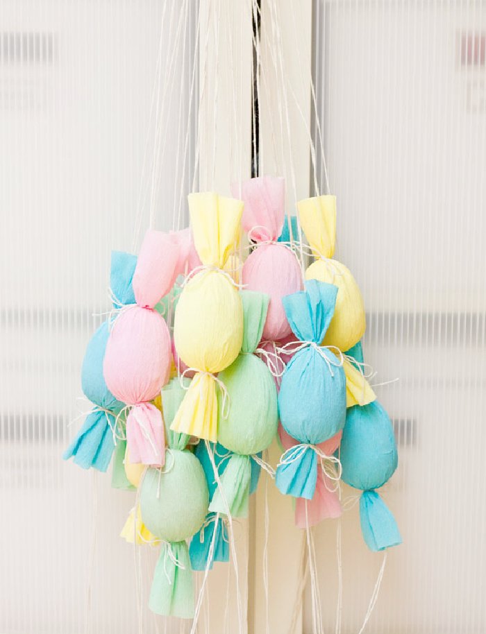 A large bunch of cheerfully Spring colored DIY Easter egg poppers  for an family Easter egg hunt with adults.