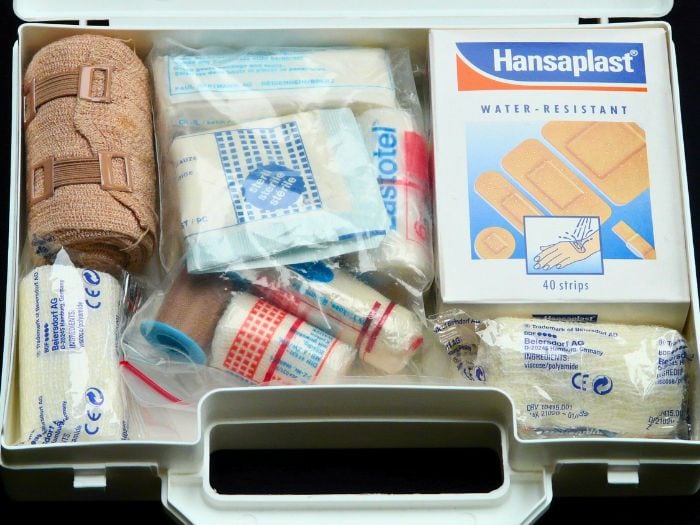 An open first aid kit showing all the different first aid supplies.