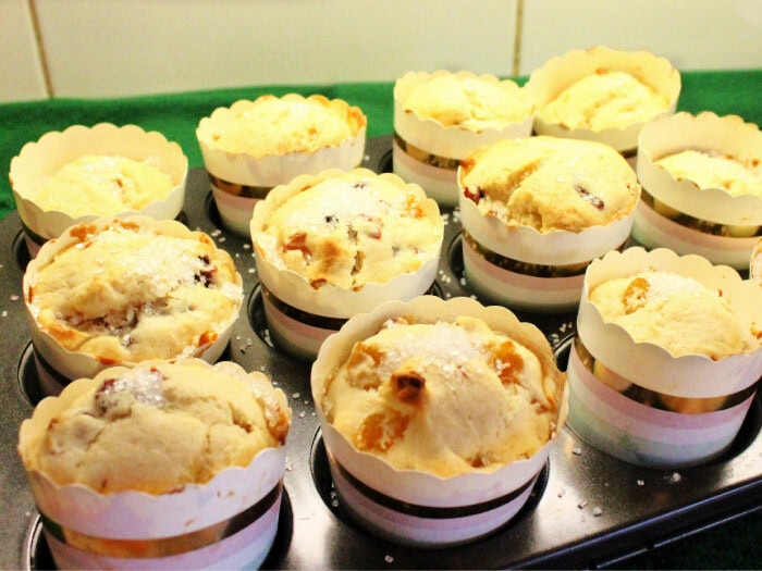 A tray of golden brown just out of the oven panettone muffins.