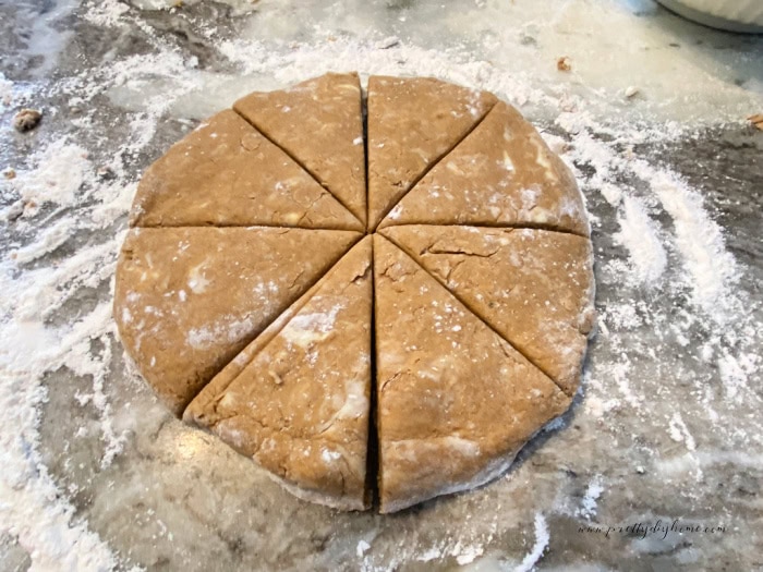 An 8-inch circle or gingerbread scone dough cut into 8 equal sized wedges.