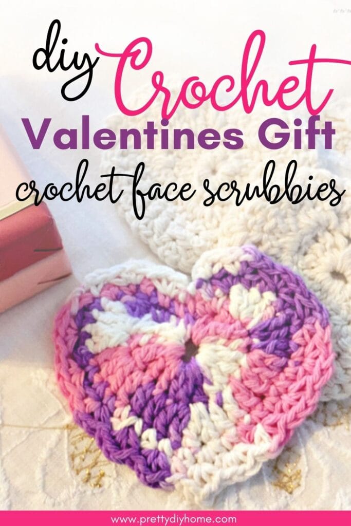 A closeup of three different handmade Valentine shaped crocheted face scrubbied.  There is a pink bar of soap in the background.  The overlay text says DIY Crochet Valentines gift crochet face scrubbies.