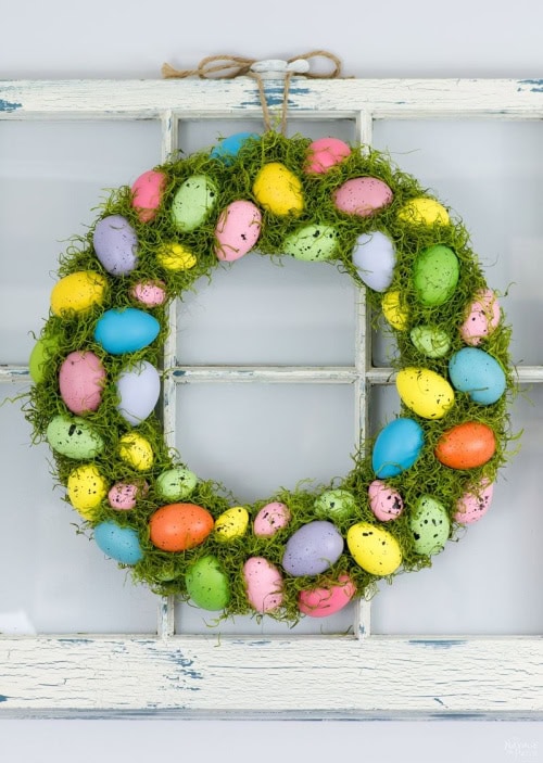 Cheerful and bright Spring wreath made with assorted Spring colored Easter eggs surrounded and stuffed with bright green moss.