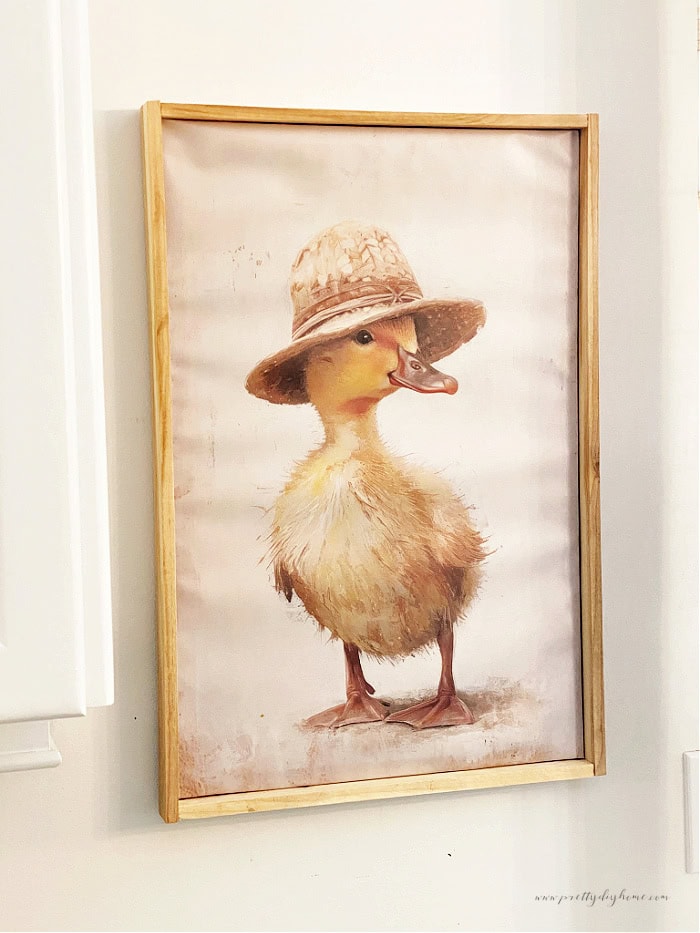 A large DIY wood picture frame with a fun duckling picture. Cute Spring decor diy.