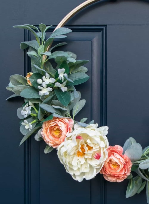 A DIY Spring wreath made with lambs ear greenery, white flowers and large blush peonies.