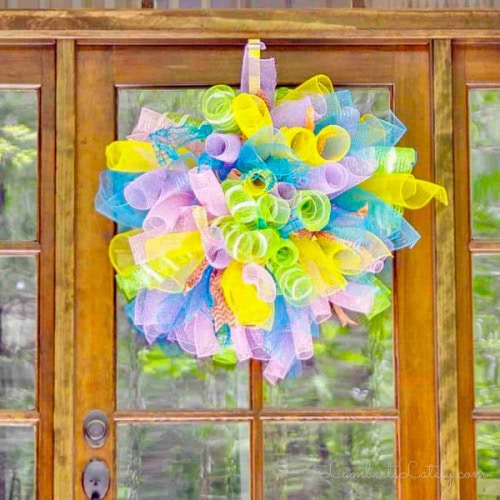 A veery bright and cheerful mesh wreath made with all sorts of curly mesh ribbon in fresh and bright Spring collors, yellow, neon green, blue, white and pink mesh.