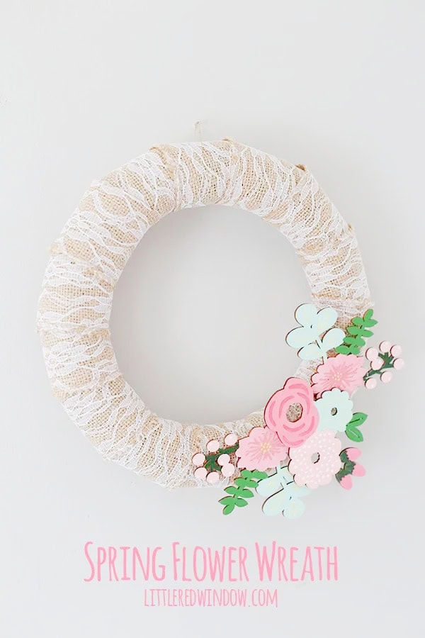 A feminine Spring wreath idea with wrapped burlap lace, and brightly painted Spring wood flowers.  