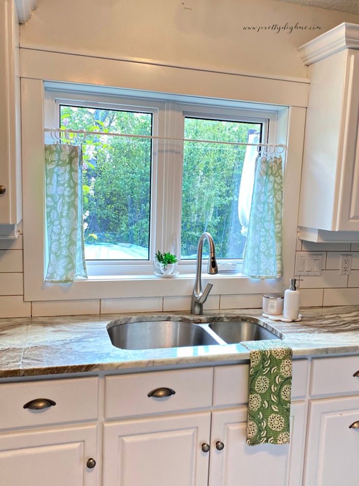 A set of kitchen window curtains in soft greens. An easy sew or no sew project using tea towels.