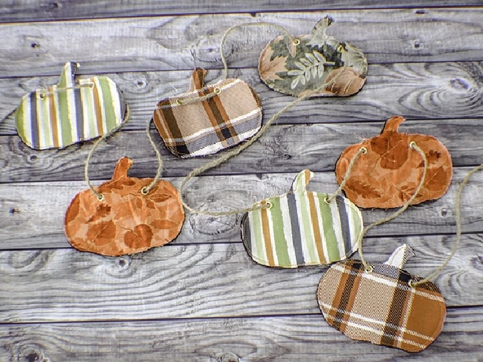 A pumpkin banner made out of various plaid fabrics in oranges, browns, greens, and white.  