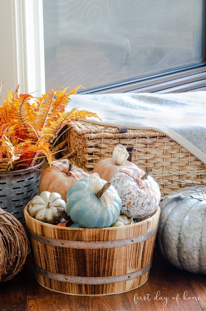 A wooden backed filled to over brimming with assorted painted and decoupage pumpkin diys. They pumpkins are in blues and cream and tangerine orange.