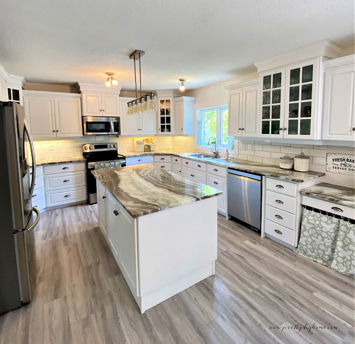 A kitchen with white cabinets DIY project. The final reveal in a kitchen cabinet makeover with white paint.