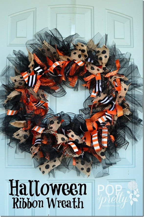 Beautifu black, natural tan, and bright Halloween tjemed ribbons gathered togrther to make a pretty Halloween wreath