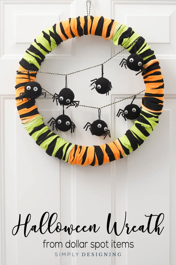 A fun and brightly colored in black, neon green and orange wreath decorated with fumny spider decorations with googly eyessss.